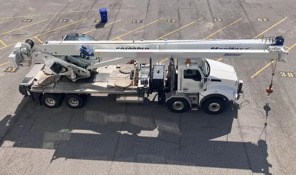 Telescopic boom truck crane parked on a street